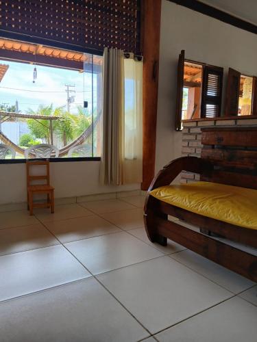 a bedroom with a bed and a large window at Cantinho do sossego in Trairi