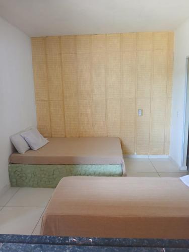 a bedroom with two beds and a window at Cantinho do sossego in Trairi