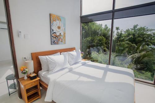 Ένα ή περισσότερα κρεβάτια σε δωμάτιο στο The Cove Bali
