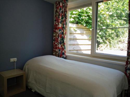 Postel nebo postele na pokoji v ubytování Villa dichtbij het strand