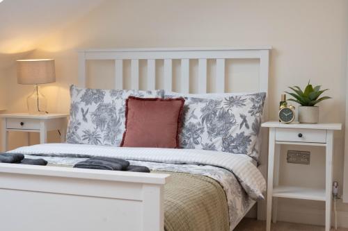 a bedroom with a white bed and two night stands at Renovated 3 Bedroom House in Lowton Pennington, free parking in Leigh