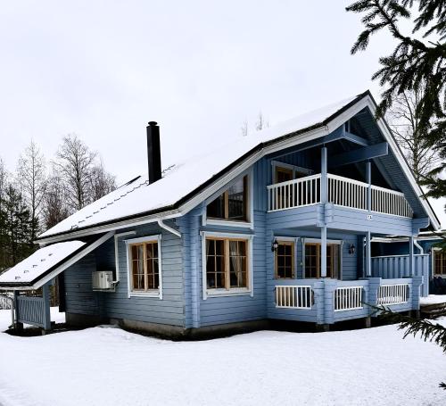 a blue house with snow on top of it at Kultaloma Slalom in Kuopio