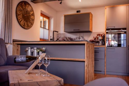 a living room with wine glasses on a wooden table at Ferienwohnung Wiagsog in Garmisch-Partenkirchen