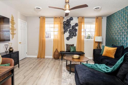 a living room with two couches and a ceiling fan at Family friendly & 5-mins to downtown Graham in Graham