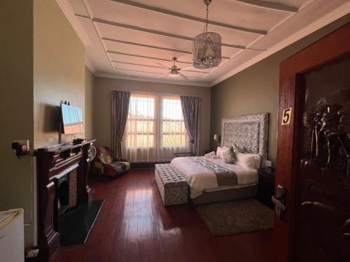 a bedroom with a bed and a tv and a window at Zensa Hotel & Spa in East London