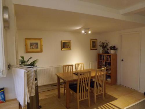 a dining room with a wooden table and chairs at peaceholm at cromer in Cromer