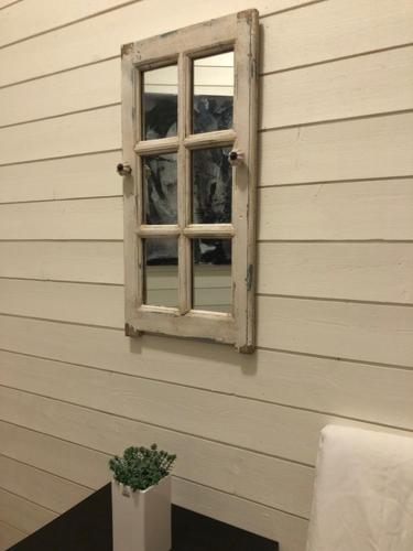 a window on the side of a house with a plant at Bashults Gård in Jönköping