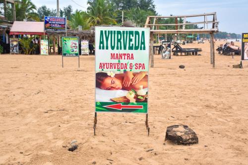 a sign in the sand on a beach at Cinnamon Mantra Luxury Villa in Beruwala