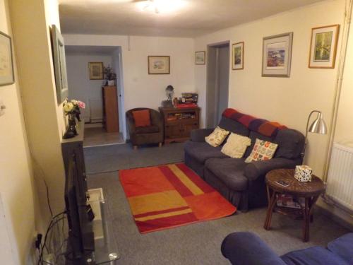 a living room with a couch and a table at peaceholm at cromer in Cromer