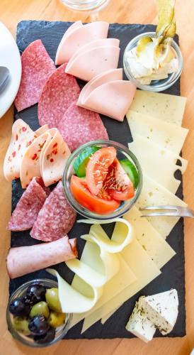 a tray of meats and cheese on a table at Hotel-Cocco-Bello in der Villa Foret in Ludwigsburg