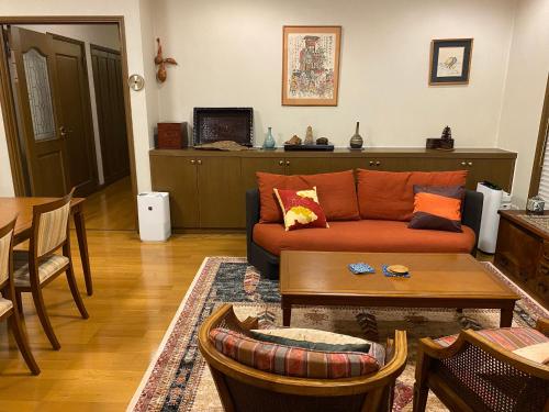 a living room with a couch and a table at S & K Garden House in Tokyo