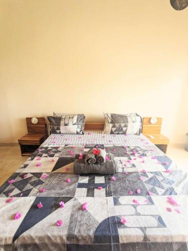 a bedroom with a bed with a stuffed animal on it at Alcyone Residence - Ocean View Villa in Muyuni