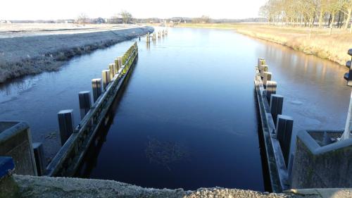 a river with a bridge over it with at B&B De SluisPod in Hoogeveen