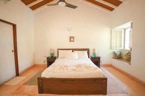 a bedroom with a large bed in a room at VILLA M - SOLITUDE 1 CANDOLIM GOA 3BHK, Pool Facing, Near Beach, Free Breakfast, Free WIFI and Prime Location in Candolim