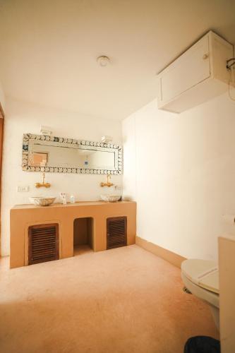 a bathroom with a sink and a mirror on the wall at VILLA M - SOLITUDE 1 CANDOLIM GOA 3BHK, Pool Facing, Near Beach, Free Breakfast, Free WIFI and Prime Location in Candolim