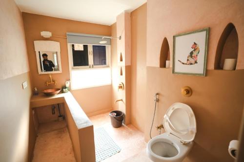 a small bathroom with a toilet and a sink at VILLA M - SOLITUDE 1 CANDOLIM GOA 3BHK, Pool Facing, Near Beach, Free Breakfast, Free WIFI and Prime Location in Candolim