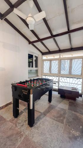a large room with a pool table in it at VILLA M - SOLITUDE 2 CANDOLIM GOA 3BHK, Pool Facing, Near Beach, Free Breakfast, Free WIFI and Prime Location in Candolim
