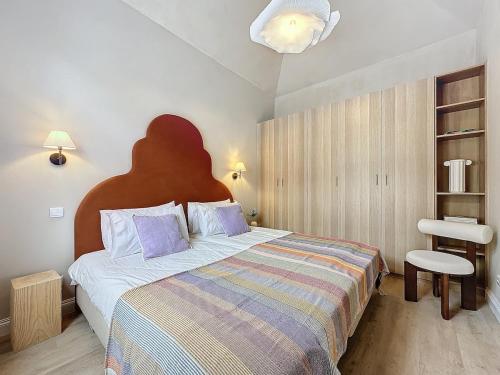 a bedroom with a large bed and a chair at THE BOAT HOUSE Sea Front and Private Pool in Funchal