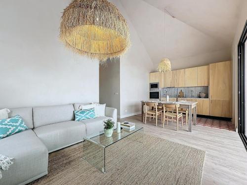 a living room with a couch and a table at THE BOAT HOUSE Sea Front and Private Pool in Funchal