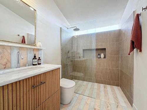 a bathroom with a shower and a toilet and a sink at THE BOAT HOUSE Sea Front and Private Pool in Funchal