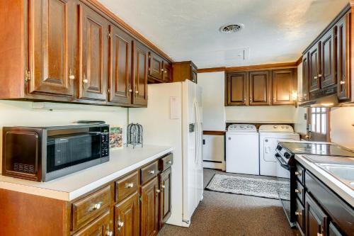 a kitchen with wooden cabinets and a white refrigerator at 9 Mi to Dtwn Gettysburg Biglerville Getaway! in Biglerville