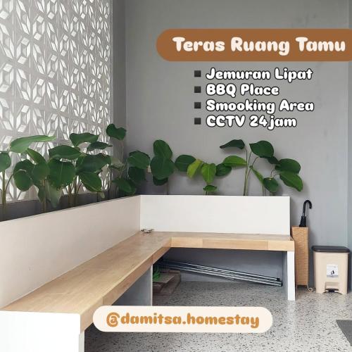 a bench in a room with a plant at Damitsa Homestay Syariah in Wonosobo