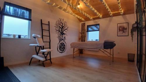 a room with a piano and a chair in it at Guesthouse with loft at lake Skagern Spa & Yoga in Finnerödja