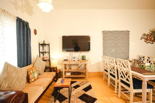 a living room with a couch and a table at VILLA M - SOLITUDE 2 CANDOLIM GOA 3BHK, Pool Facing, Near Beach, Free Breakfast, Free WIFI and Prime Location in Candolim