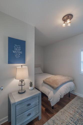 a bedroom with a bed and a table with a lamp at Loft On Landess in Marion