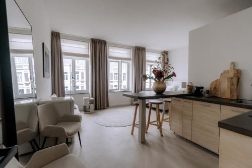 a kitchen with a table and chairs in a room at W Y C K - E N D boutique hotel in Maastricht