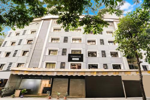 a large white building with a sign on it at Super Townhouse Marol Near Mumbai Airport in Mumbai