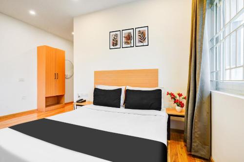 a bedroom with a large bed and a window at Super Townhouse RR Nagar in Bengaluru