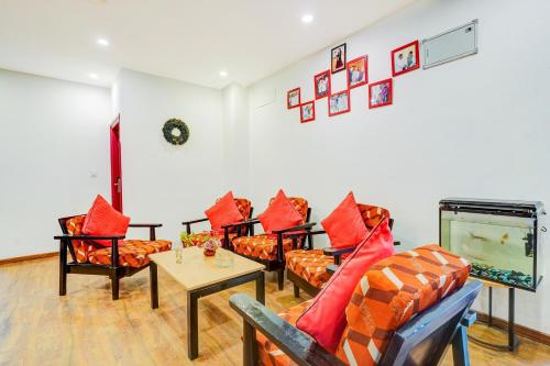 a living room with couches and a flat screen tv at Super Townhouse RR Nagar in Bengaluru