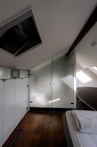 a bedroom with a bed and a glass wall at W Y C K - E N D boutique hotel in Maastricht