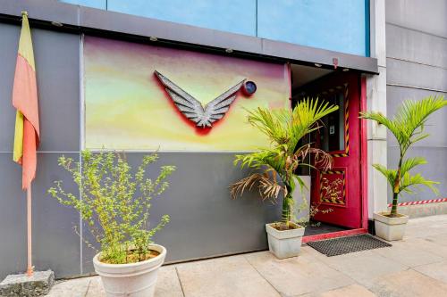 a painting of a butterfly on the side of a building at Super Townhouse RR Nagar in Bengaluru
