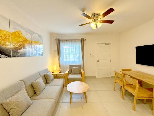 a living room with a couch and a table at Bon Bini Suites in Oranjestad
