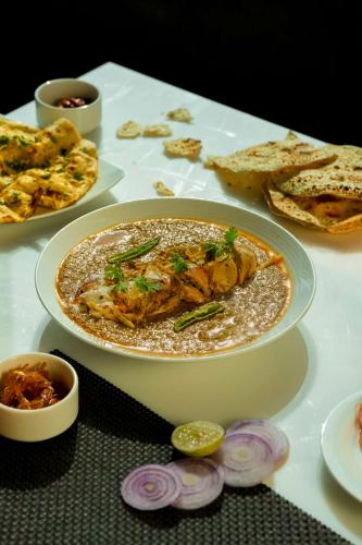 a table with a plate of food on a table at Radisson Blu Pune Hinjawadi in Pune