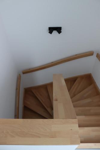 a staircase with a wooden table in a room at Apartmán Nerudova Terasa in Polná