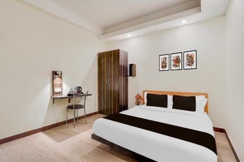 a hotel room with a bed and a desk at Super Hotel O Upper Bazar formerly RR Residency in Rānchī
