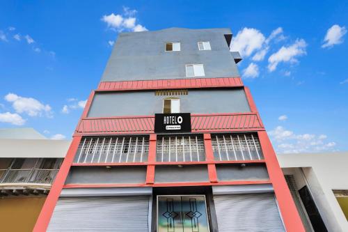 a tall red building with a sign on it at Super Hotel O Upper Bazar formerly RR Residency in Rānchī