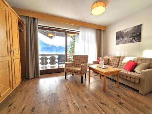 a living room with a couch and a table at Hotel Cafe Fuggerhof in Oberstdorf