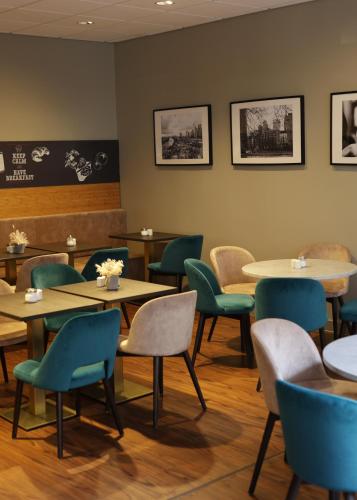 a dining room with tables and chairs and a chalkboard at ibis Frankfurt Centrum in Frankfurt/Main