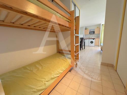 Cette chambre comprend des lits superposés et une cuisine. dans l'établissement studio vue mer parking piscine tennis, à Sète