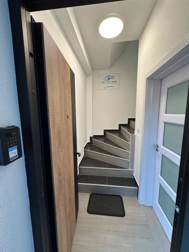 a hallway with a staircase with a door and a stair mat at Luz del Mar in Kumbor
