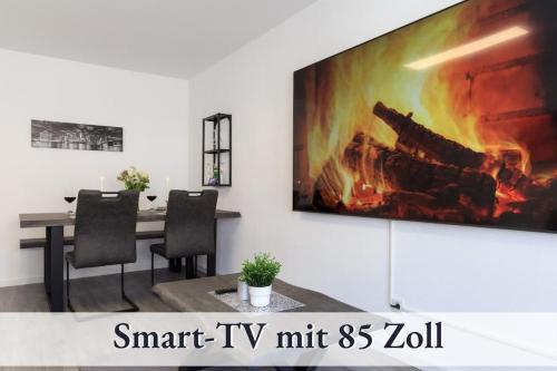 a tv hanging on a wall with a fireplace at Relax-Apartment-One FN in Friedrichshafen