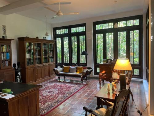 a living room with a couch and a table at Birders Urban Retreat in Sri Jayewardenepura Kotte