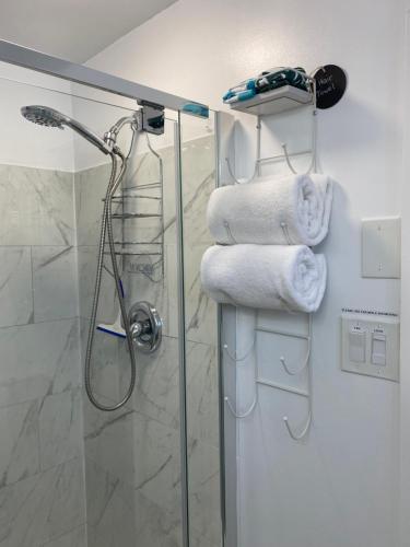 a bathroom with a shower and some towels at Our Place Up North BnB in Huntsville