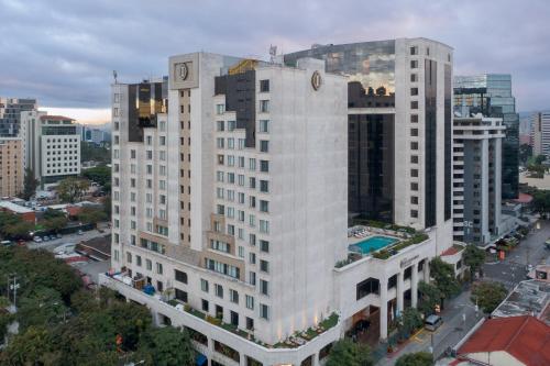 a large white building with a clock on top of it at Intercontinental Real Guatemala by IHG in Guatemala