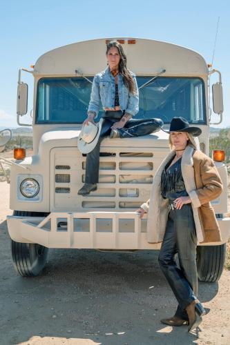 a man and a woman standing on the front of a truck at Secluded-jt-spa-pool-firepit-sauna-game Room! in Yucca Valley