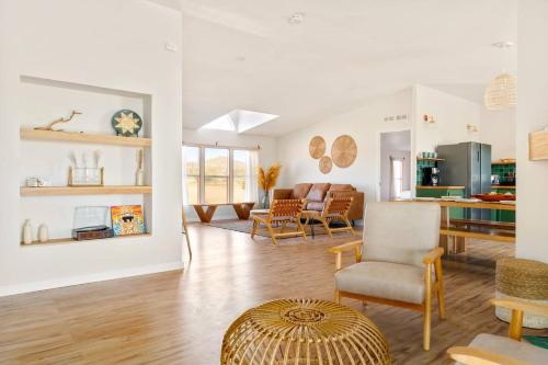a living room with white walls and a table and chairs at Secluded-jt-spa-pool-firepit-sauna-game Room! in Yucca Valley